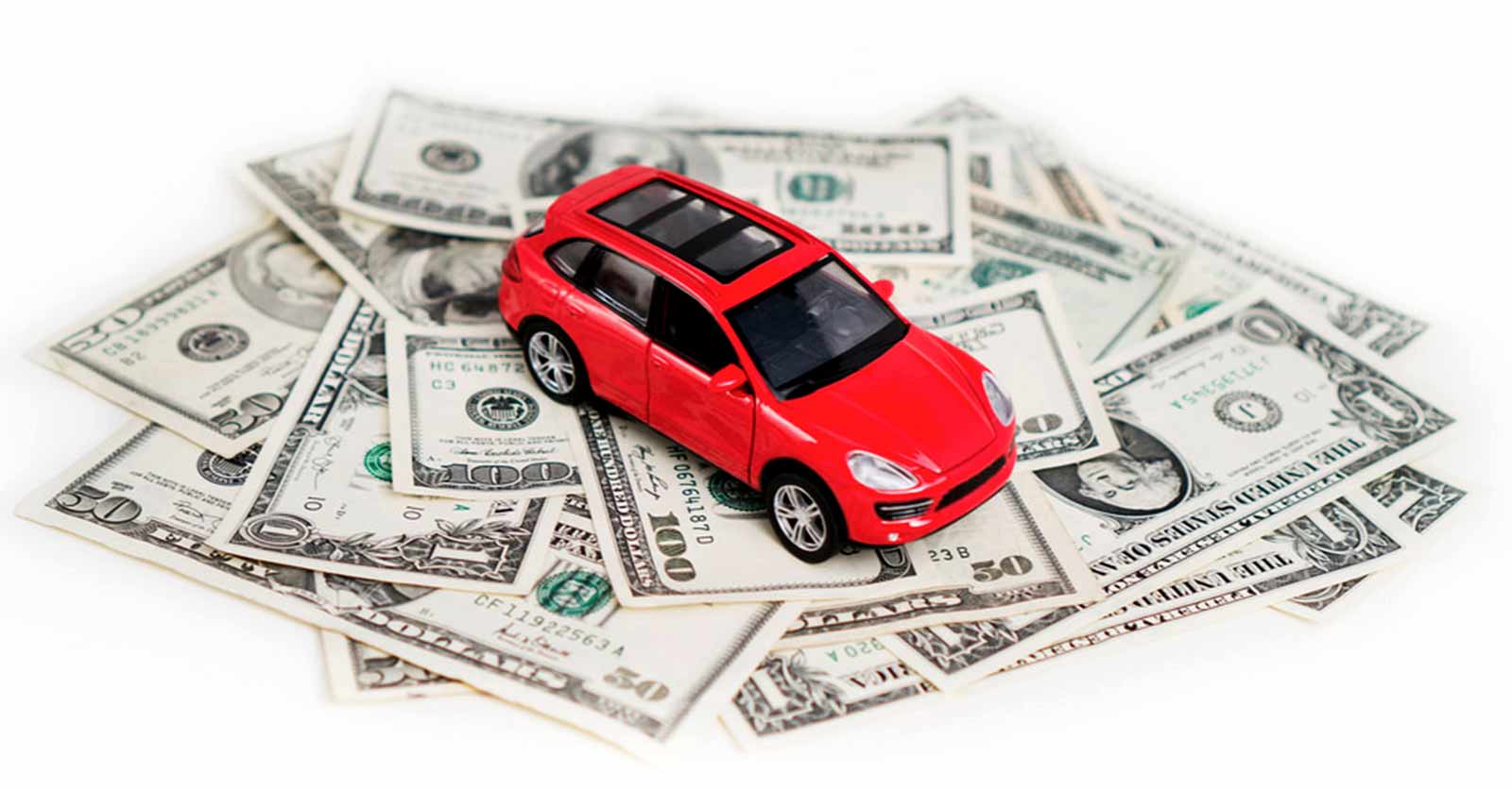 toy car sitting on top of a pile of money