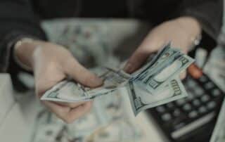 person counting collars with a calculator in the background