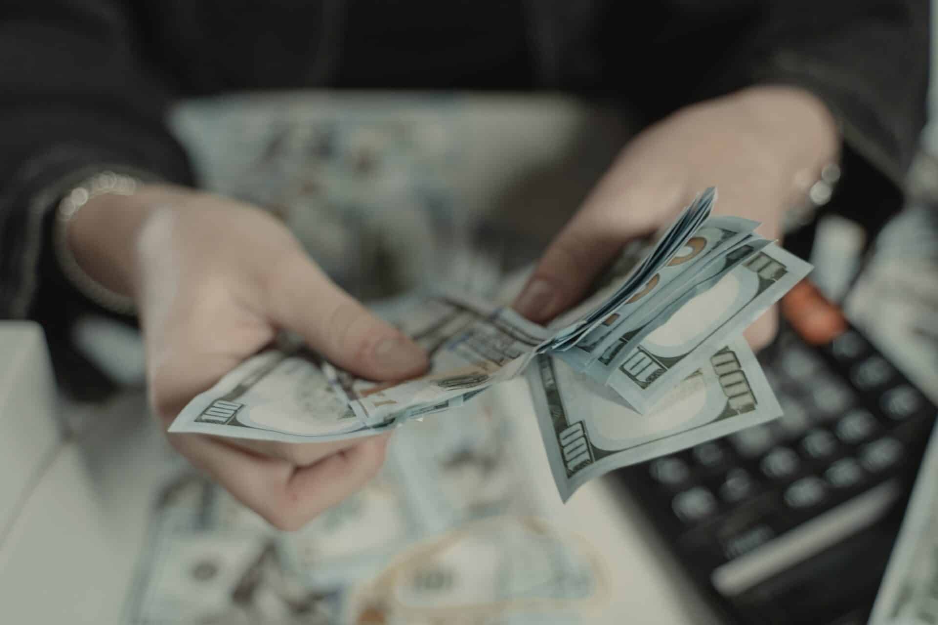 person counting collars with a calculator in the background