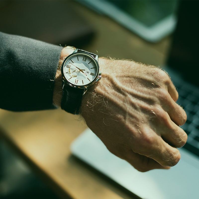 man looking at wristwatch