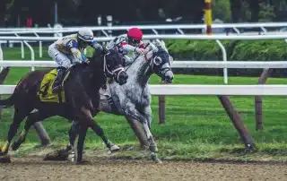 Two horse-riders racing at a racecourse