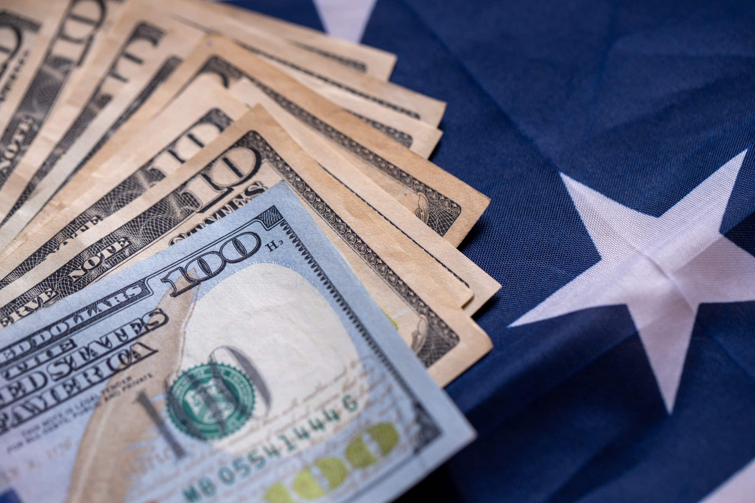 Stack of money on top of US flag