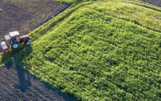 aerial image of a field with a tractor in the corner