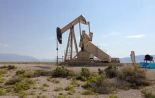 An oil pumpjack with a blue sky in the background