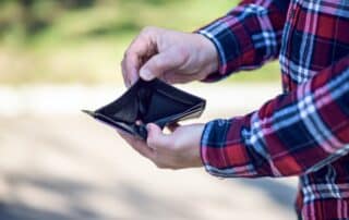 Man opening empty wallet