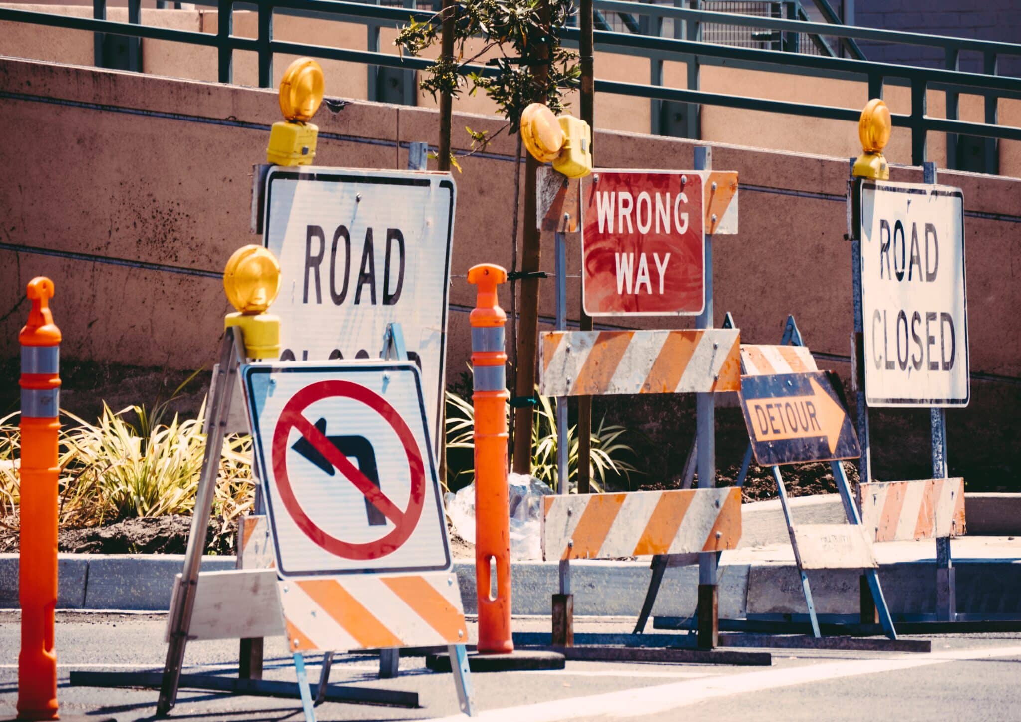 Road signs reading "road closed" and "wrong way" in Los Angeles.