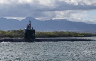 A grey submarine immersed in water