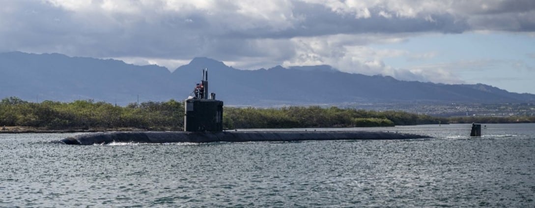 A grey submarine immersed in water