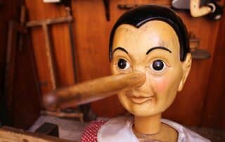 A wooden Pinocchio doll with an elongated nose