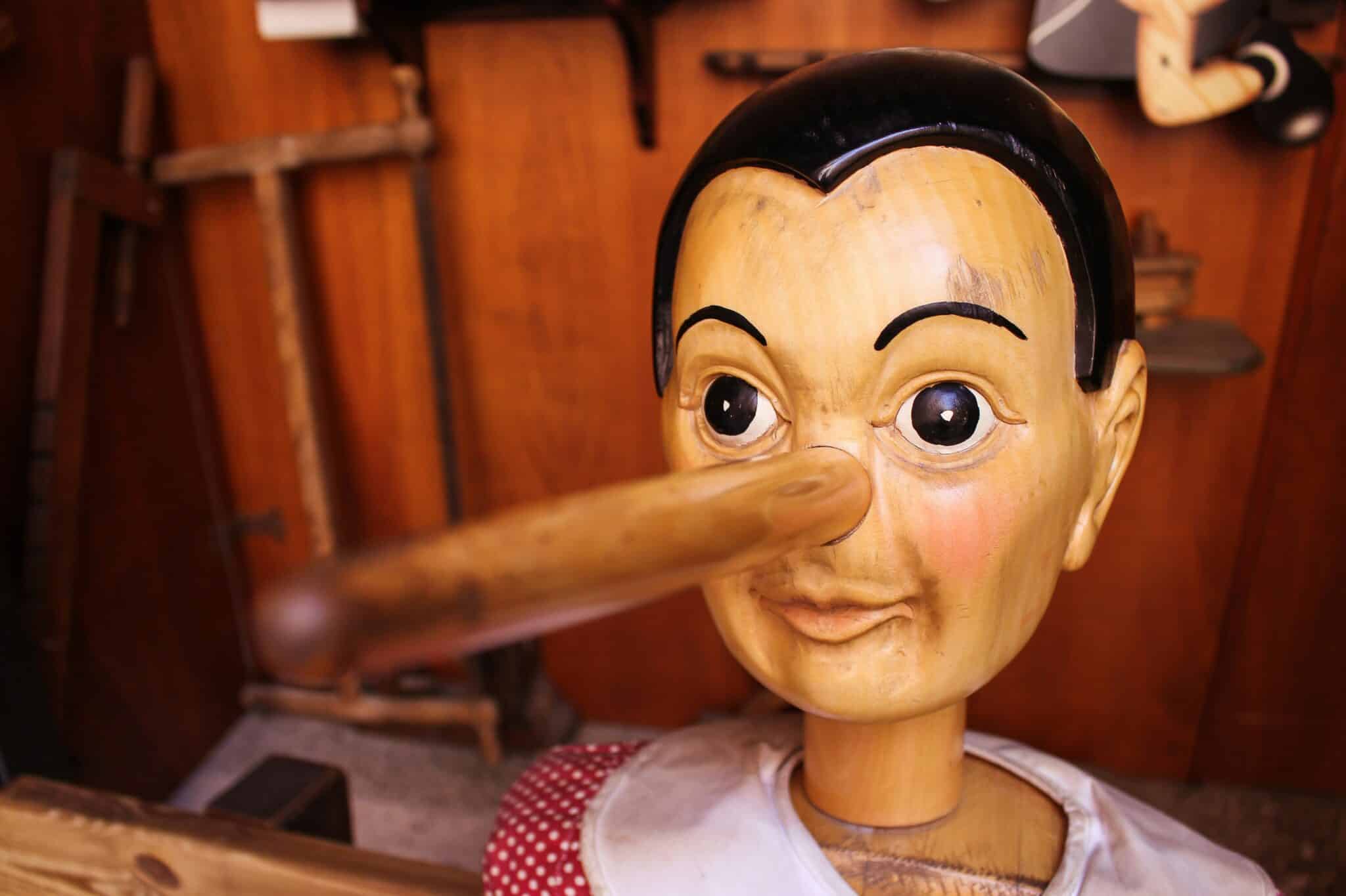 A wooden Pinocchio doll with an elongated nose