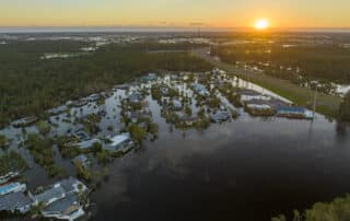 Drone image of a sunset over a flooded residential area in Florida