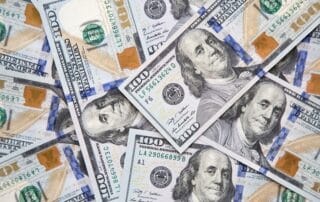 piles of hundred dollar bills