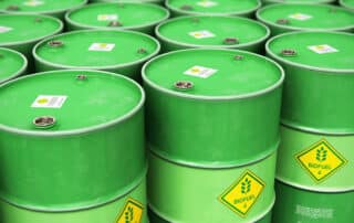 Green Biofuel drums with a yellow warning diamond that reads "BIOFUELS" in green.