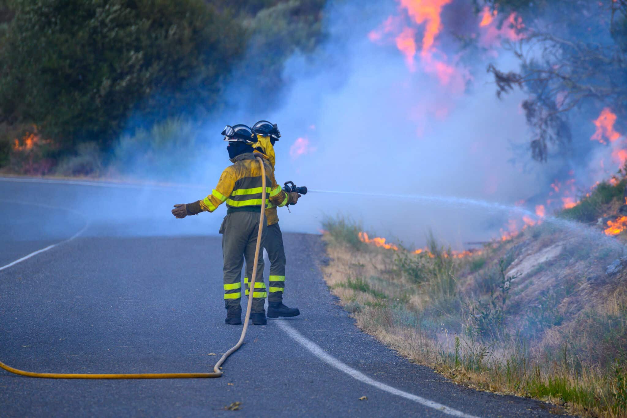 Two Firefighters Facing a Huge Wall of Flames scaled