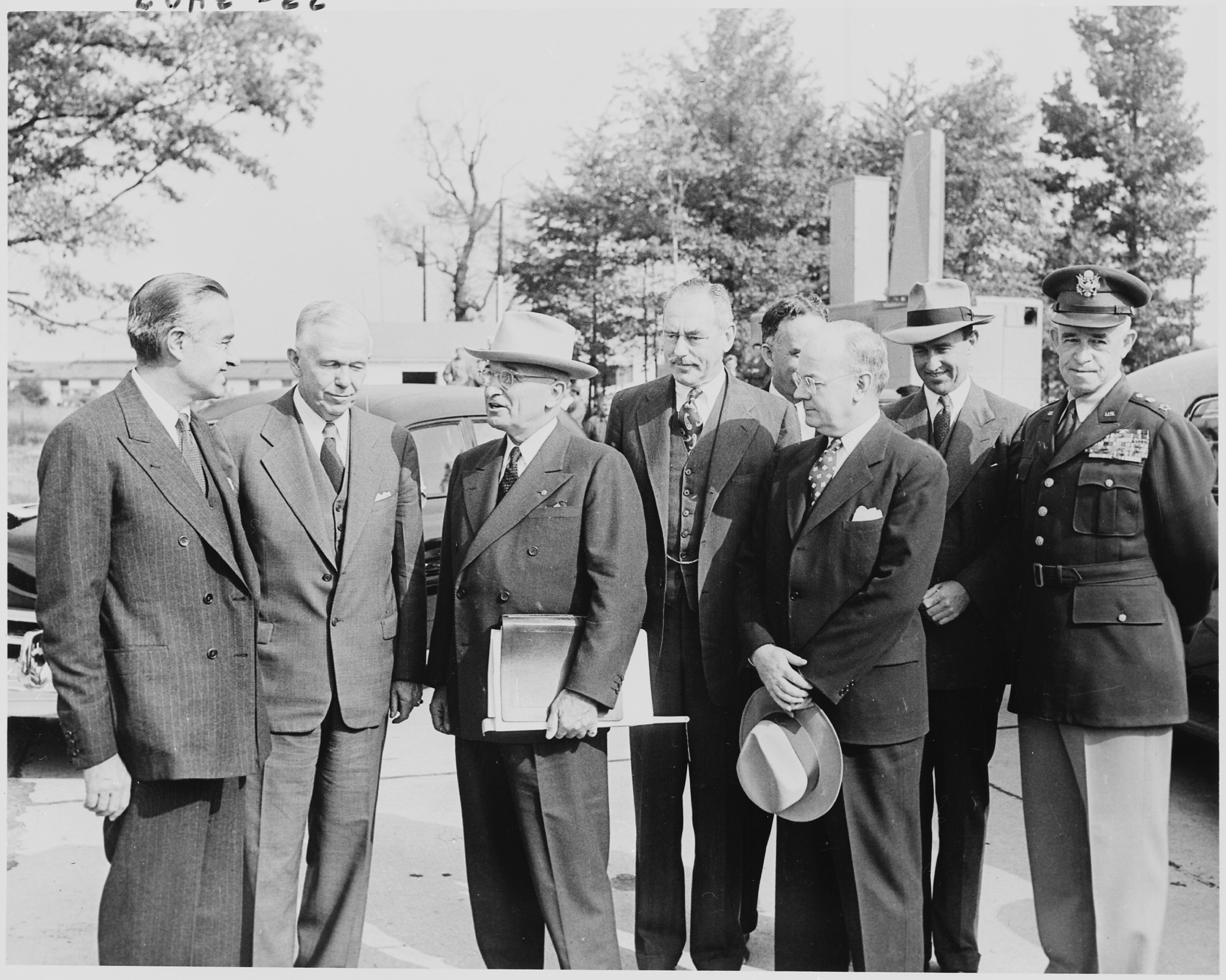 Black and white photograph of President Truman with his some of his top advisers, upon his return to Washington from the Wake Island
